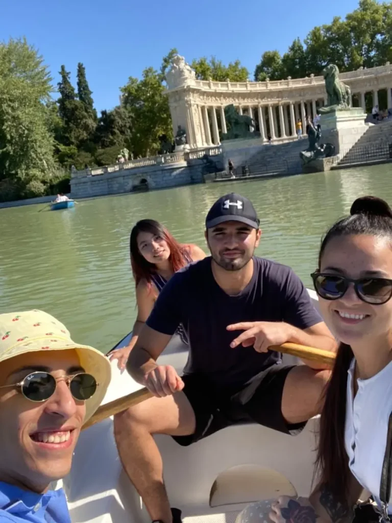 Group enjoying a rowboat ride on the lake at Retiro Park in Madrid