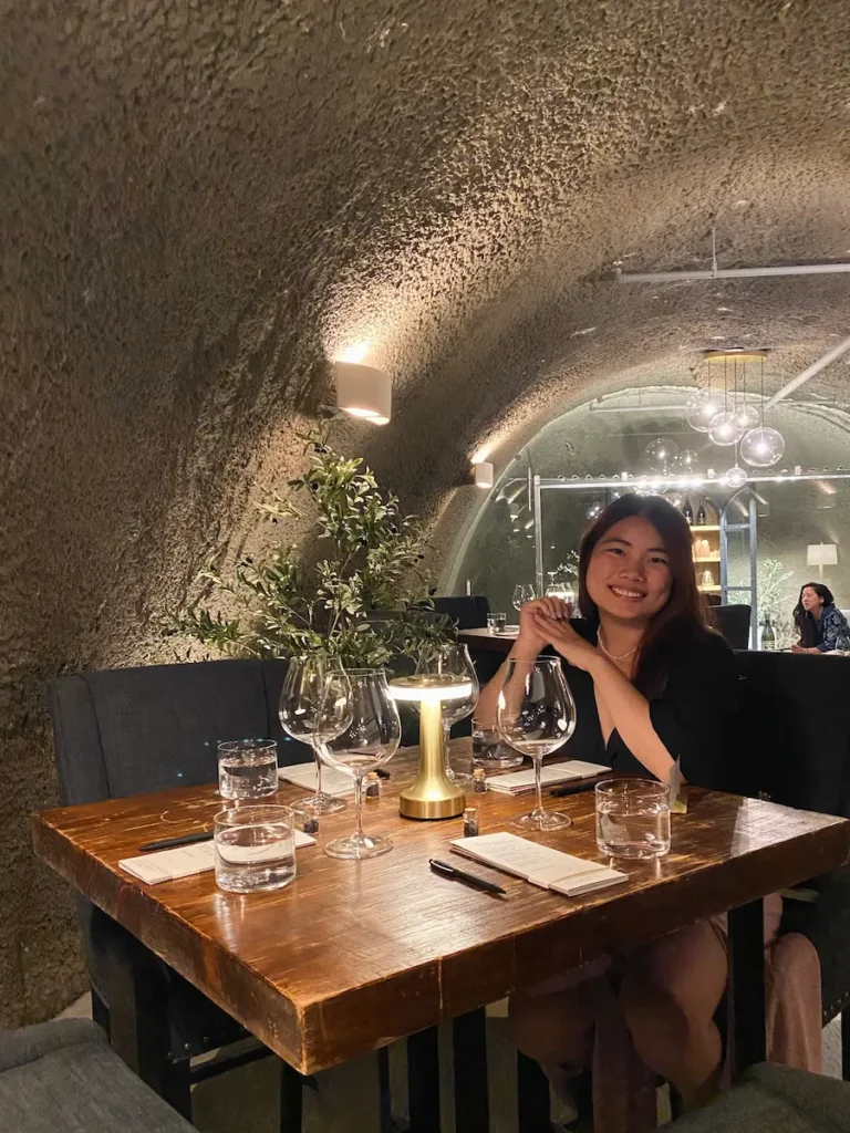 Solo traveler sitting at a cozy wine tasting table at Archery Summit in Portland, Oregon.