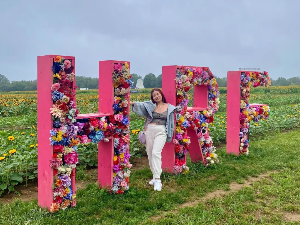 Colorful floral HRF sign at Holland Ridge Farms, a popular Instagram spot during the Sunflower Festival.