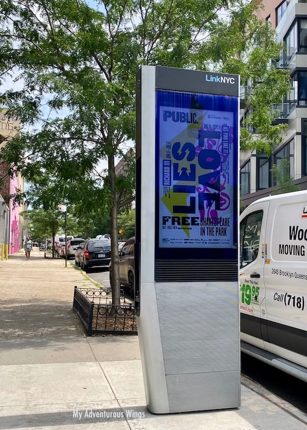 LinkNYC kiosk at the corner of a street in NYC where you can get free wifi